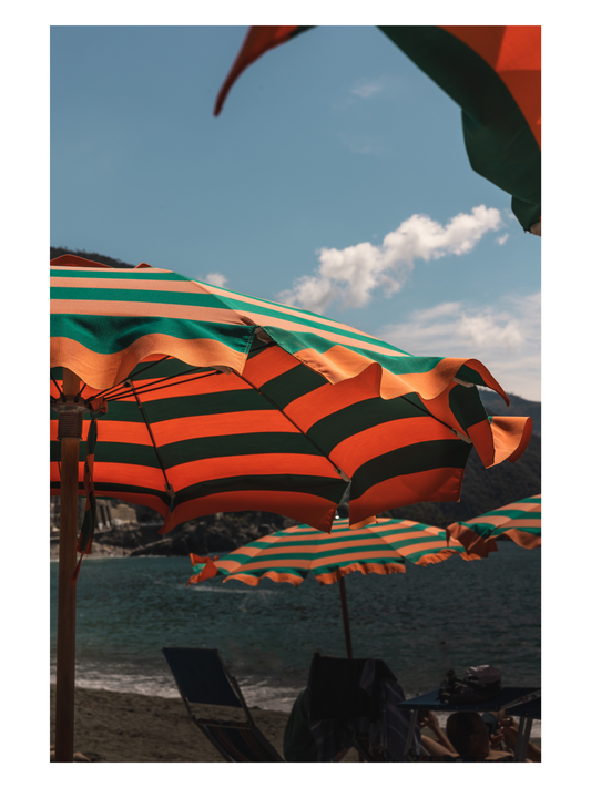 Fånga Fine Art Print  beach with green and orange striped umbrellas